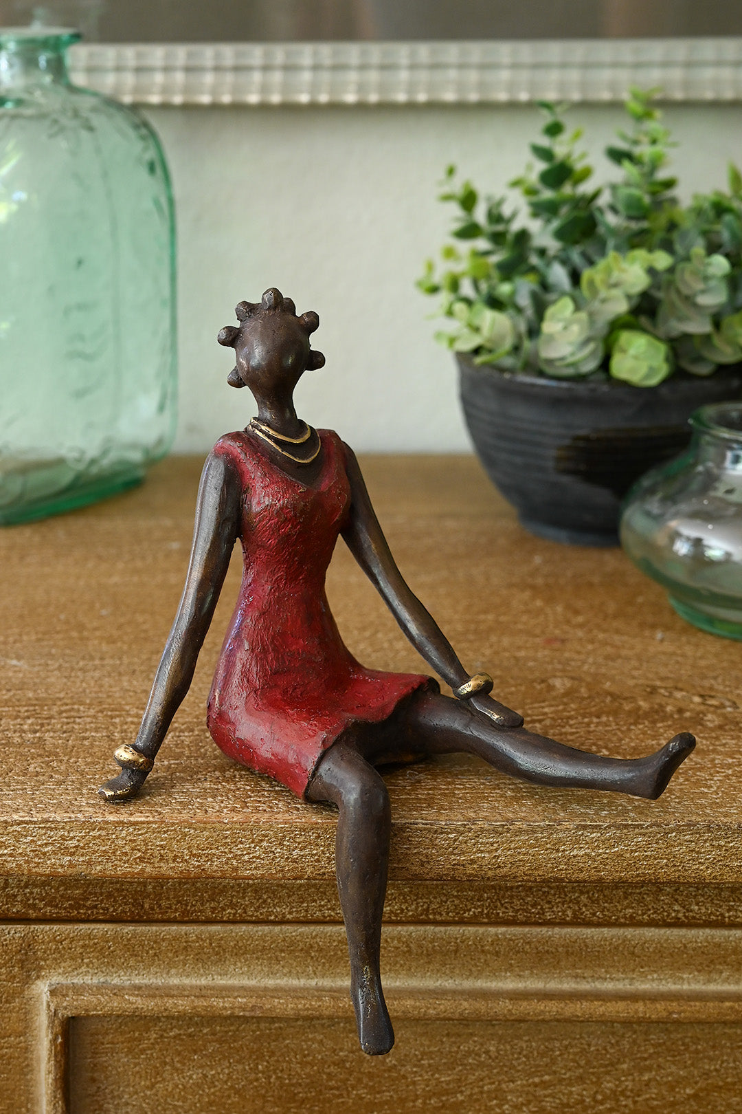 Bronze Sculpture of Woman with Bantu buns, red dress, reclining | African Art, Fair Trade, Burkina Faso